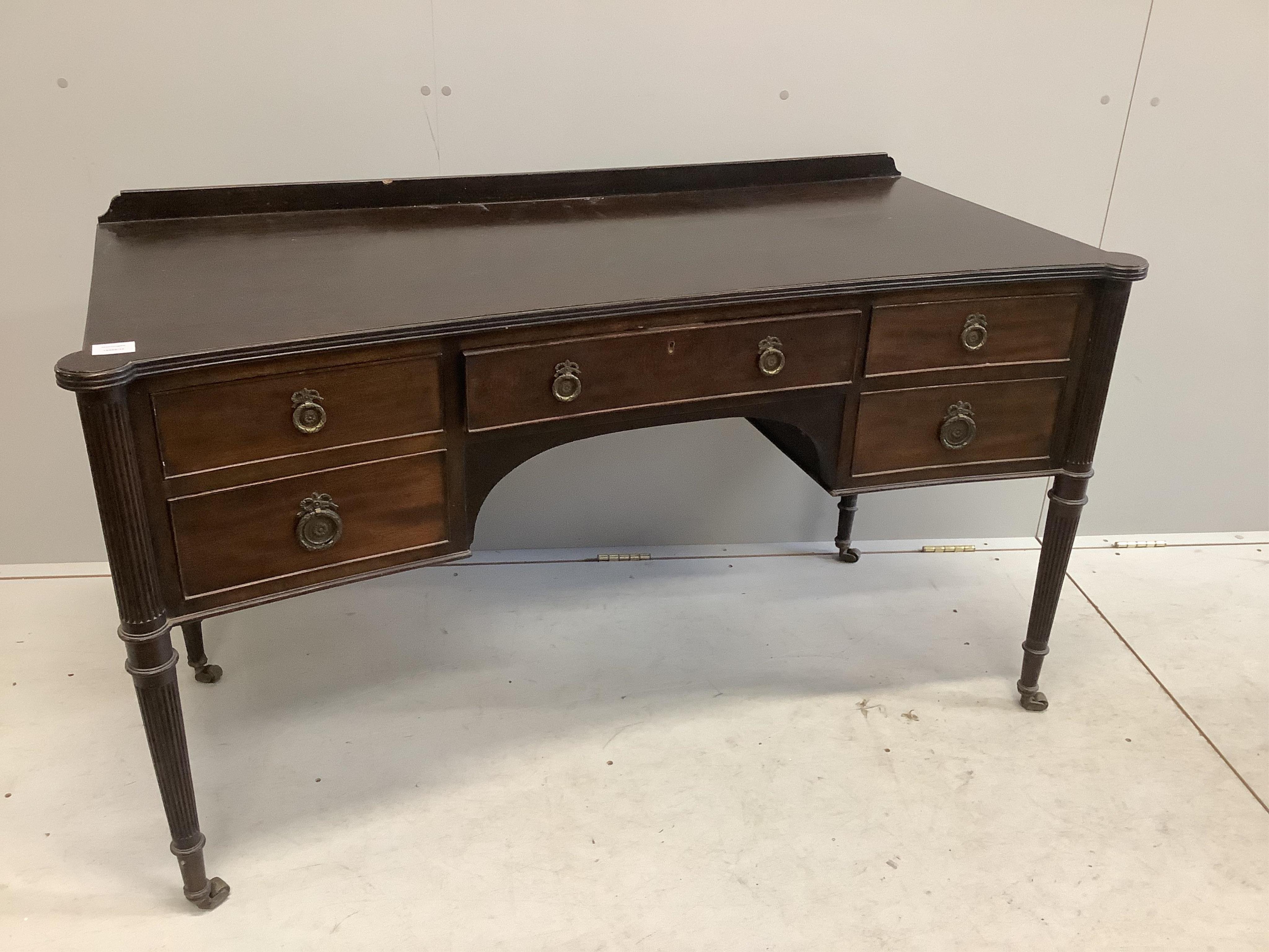 An early 20th century mahogany concave kneehole dressing table, width 136cm, depth 60cm, height 78cm. Condition - fair